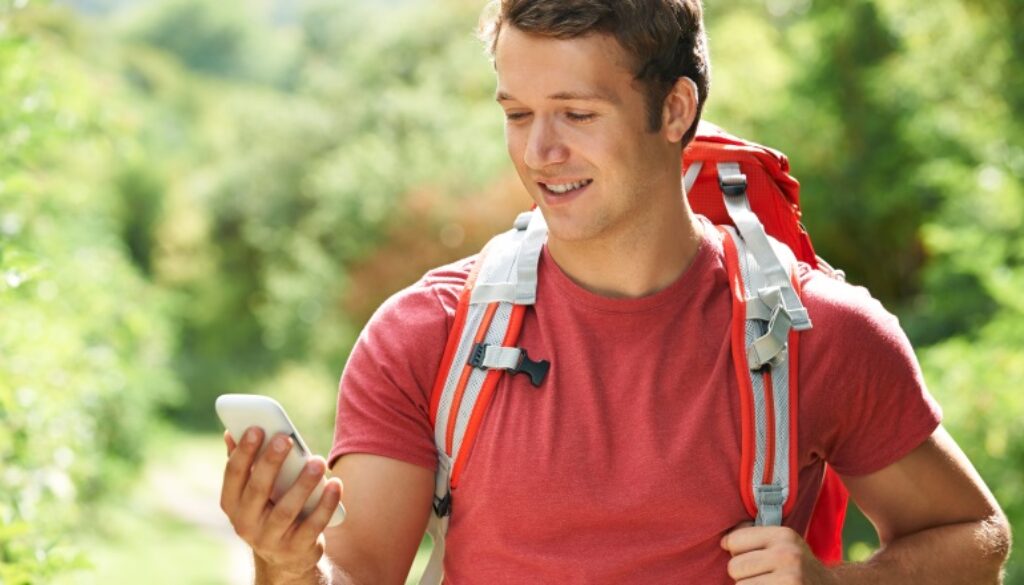 Man Checking Location With Mobile Phone On Hike