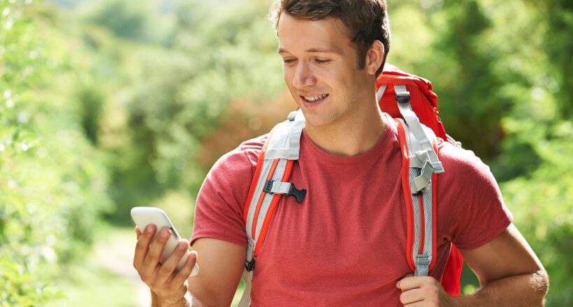 Man Checking Location With Mobile Phone On Hike