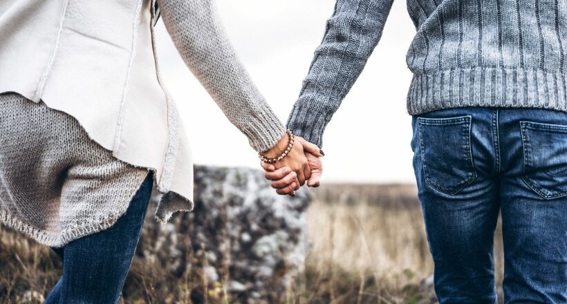 Photo of romatic couple hands, walking outdoor and spending time together.